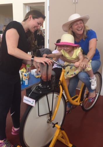 Community Events - Child  Mum laughing on smoothie bike